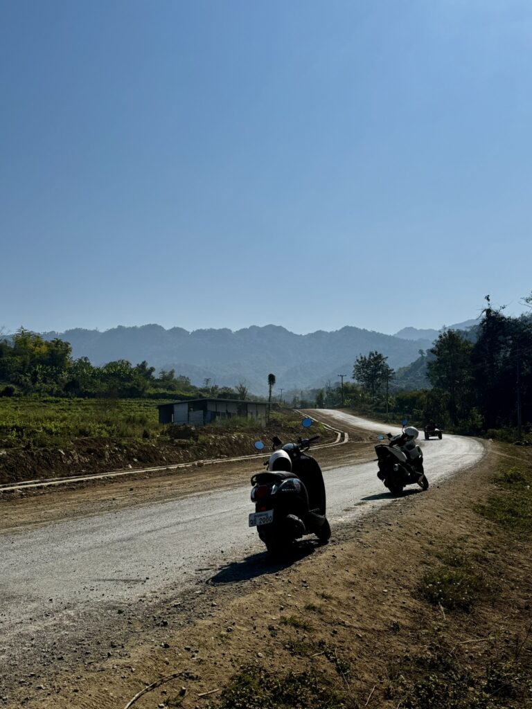 Riding scooters in Laos